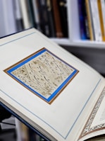 Open book showing a page of hand-lettered calligraphy and illustrations.