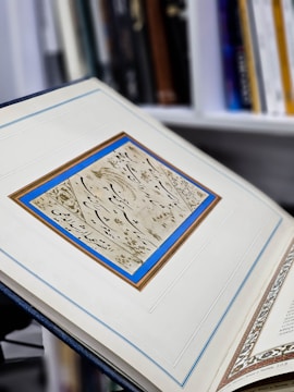 An open book displaying a beautifully designed page with a gold border and modern typography.