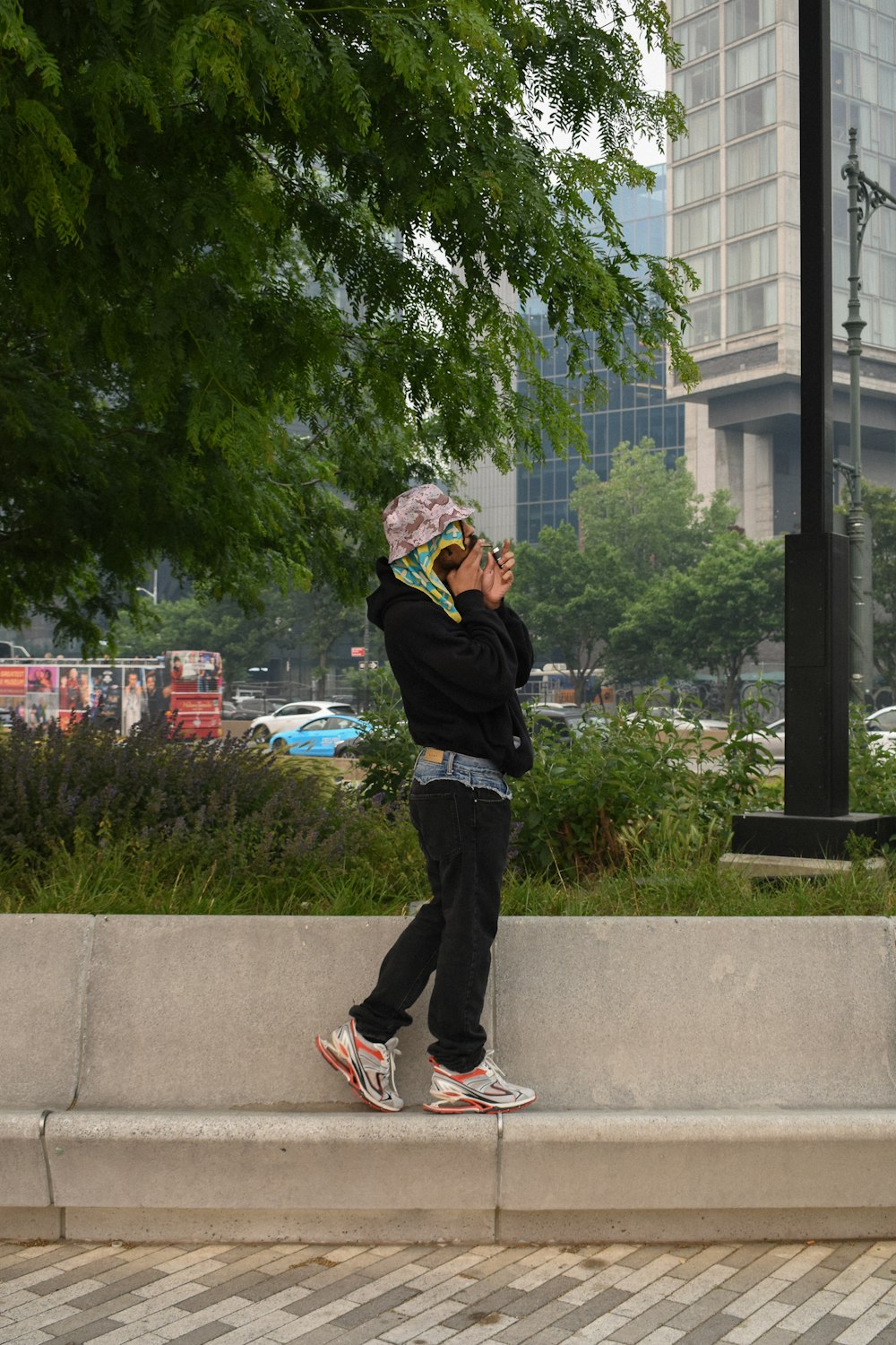 a person standing on a ledge with a cell phone