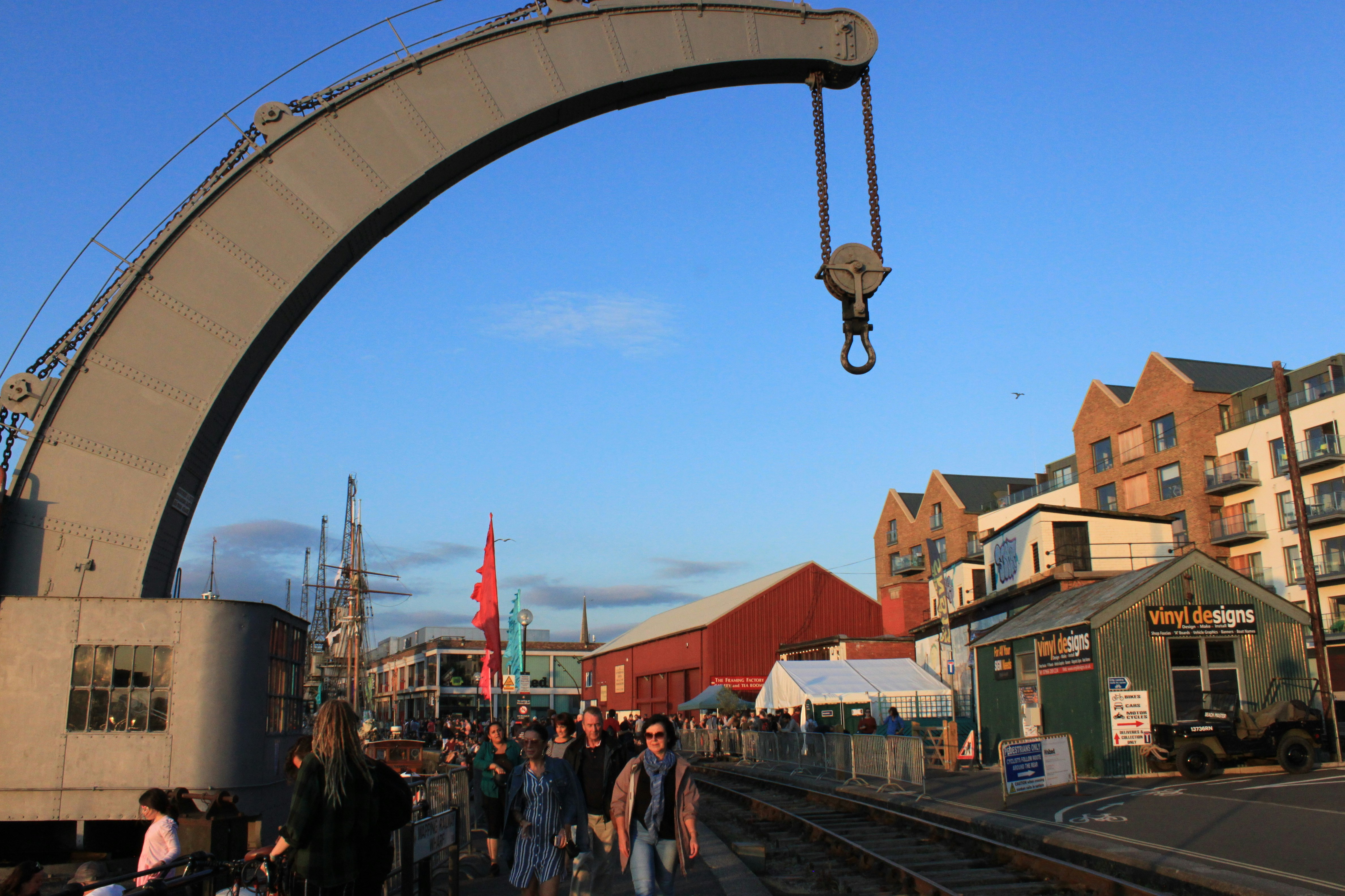 a group of people walking down a train track