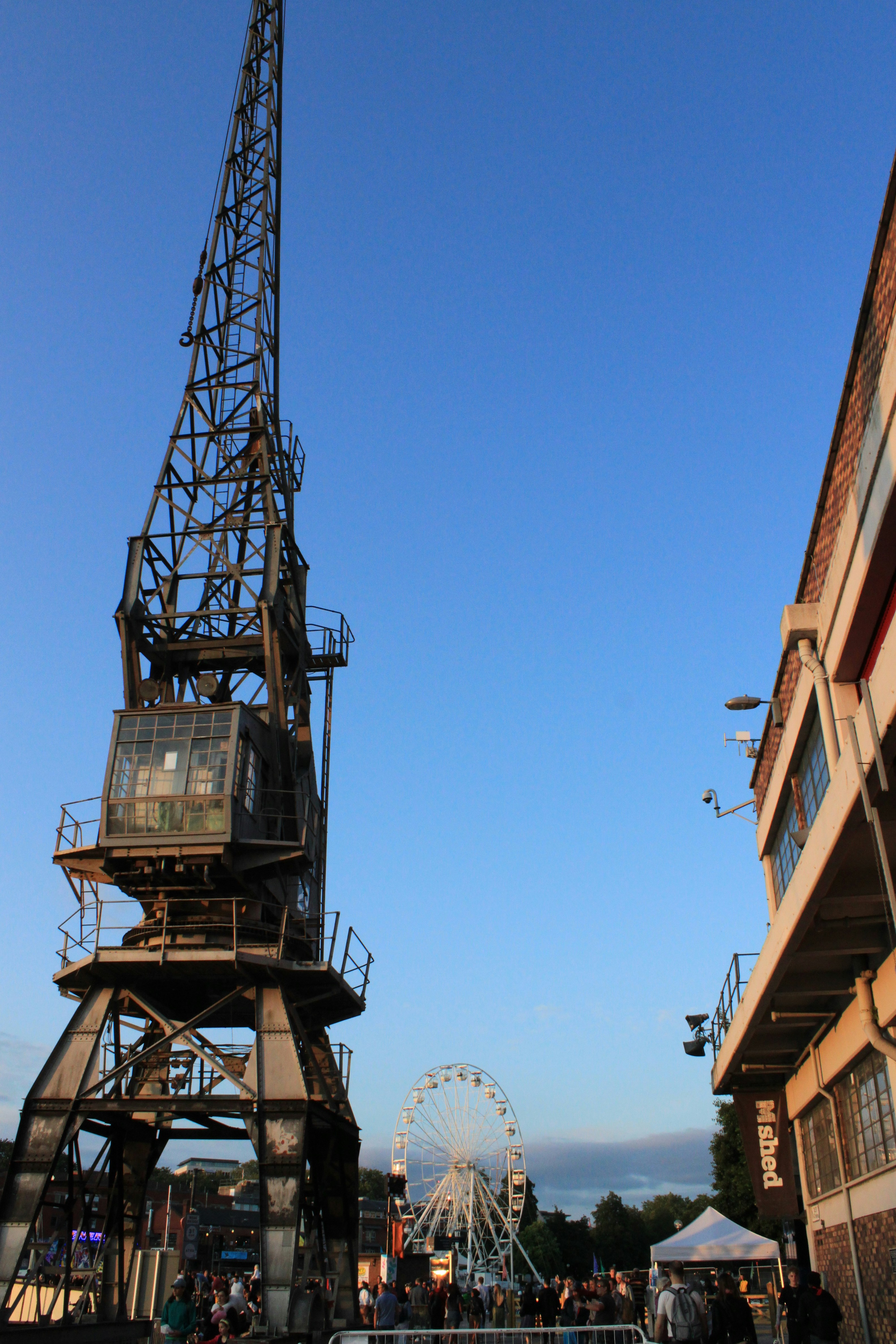 a ferris wheel sitting next to a tall building
