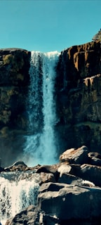 a large waterfall with water coming out of it