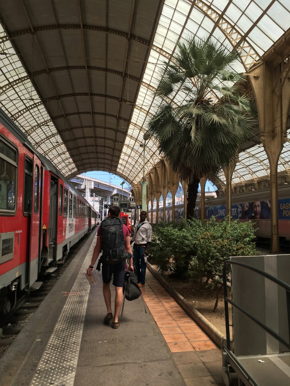 a group of people that are standing next to a train