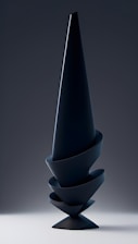 A sleek, minimalist sculpture in deep obsidian and gold, symbolizing the spiral flow of energy and sovereignty.