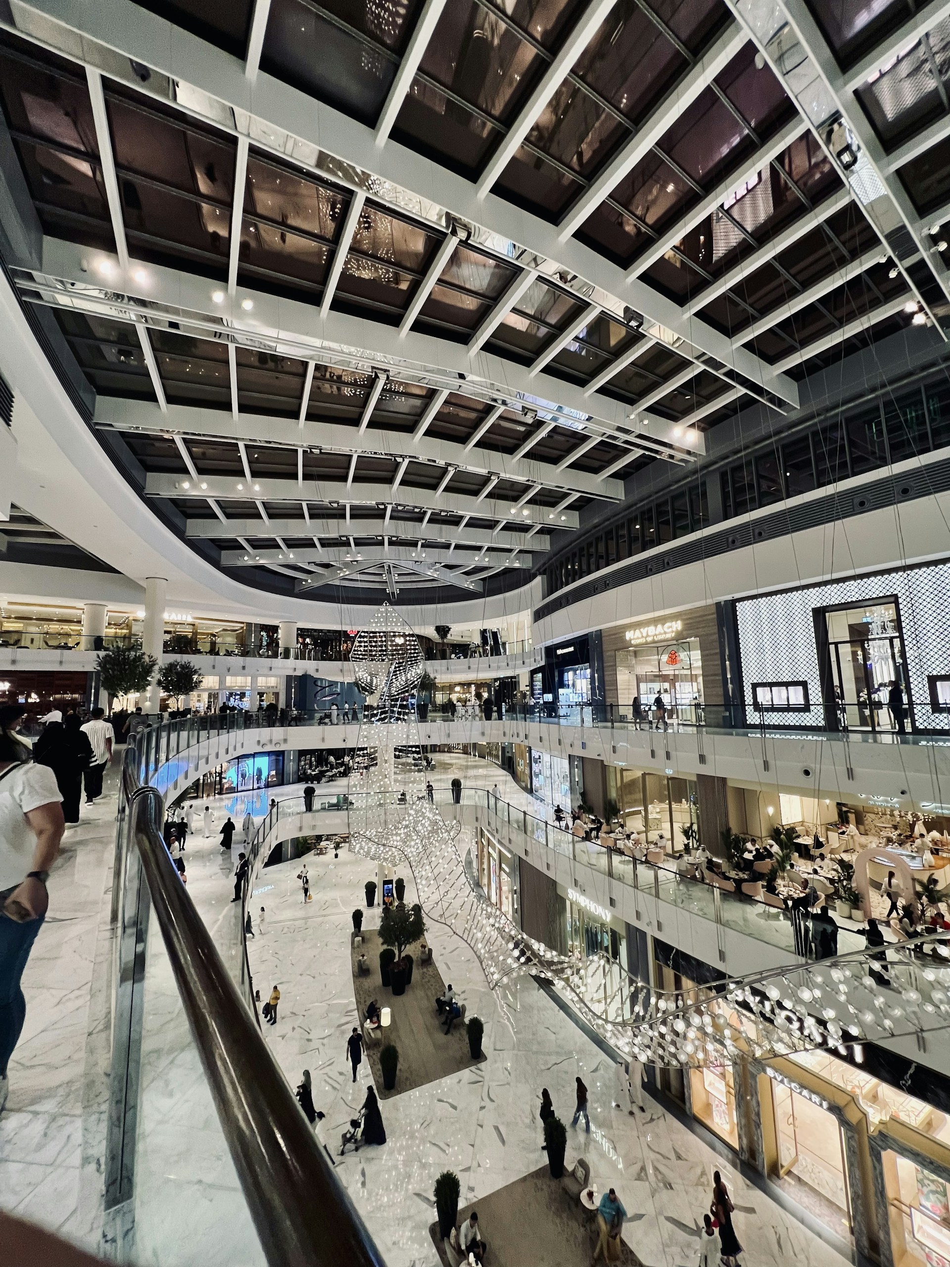 a group of people walking around a shopping mall