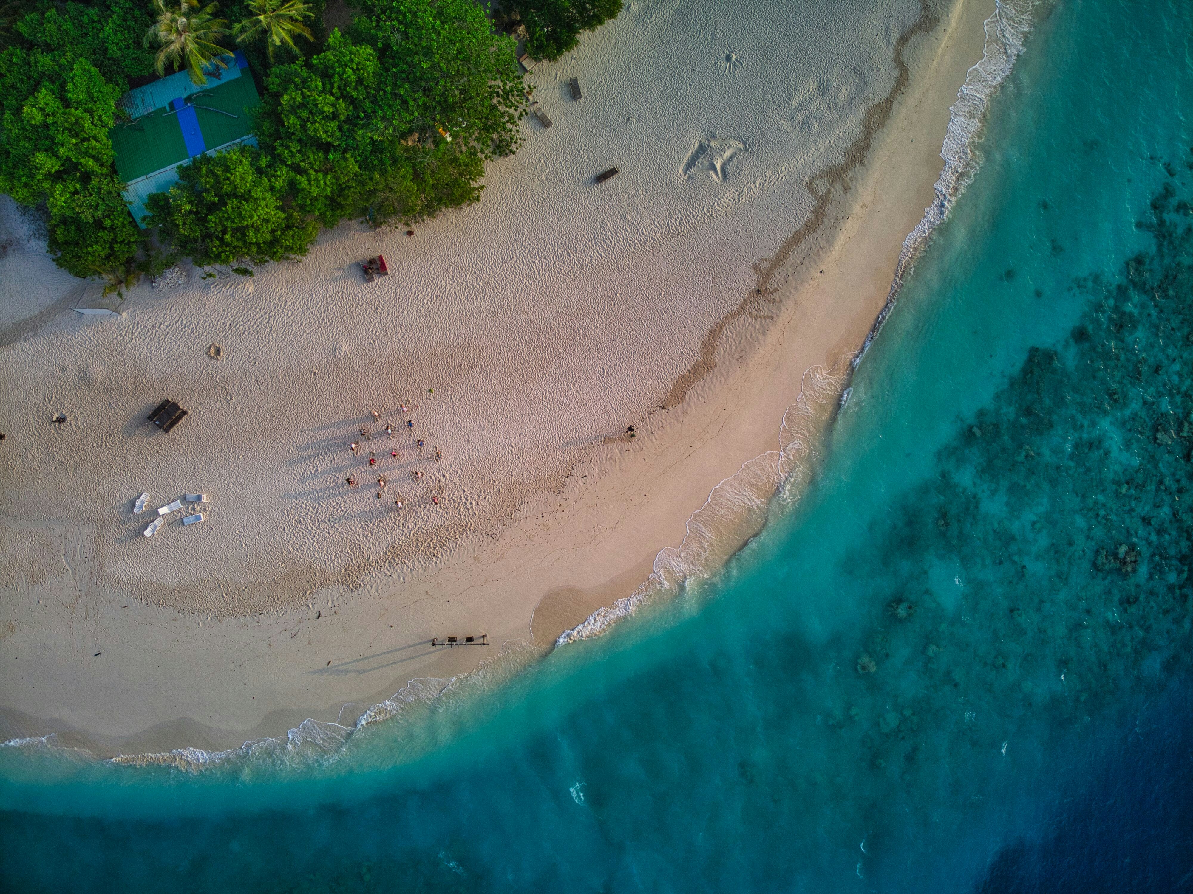 an aerial view of a sandy beach and ocean