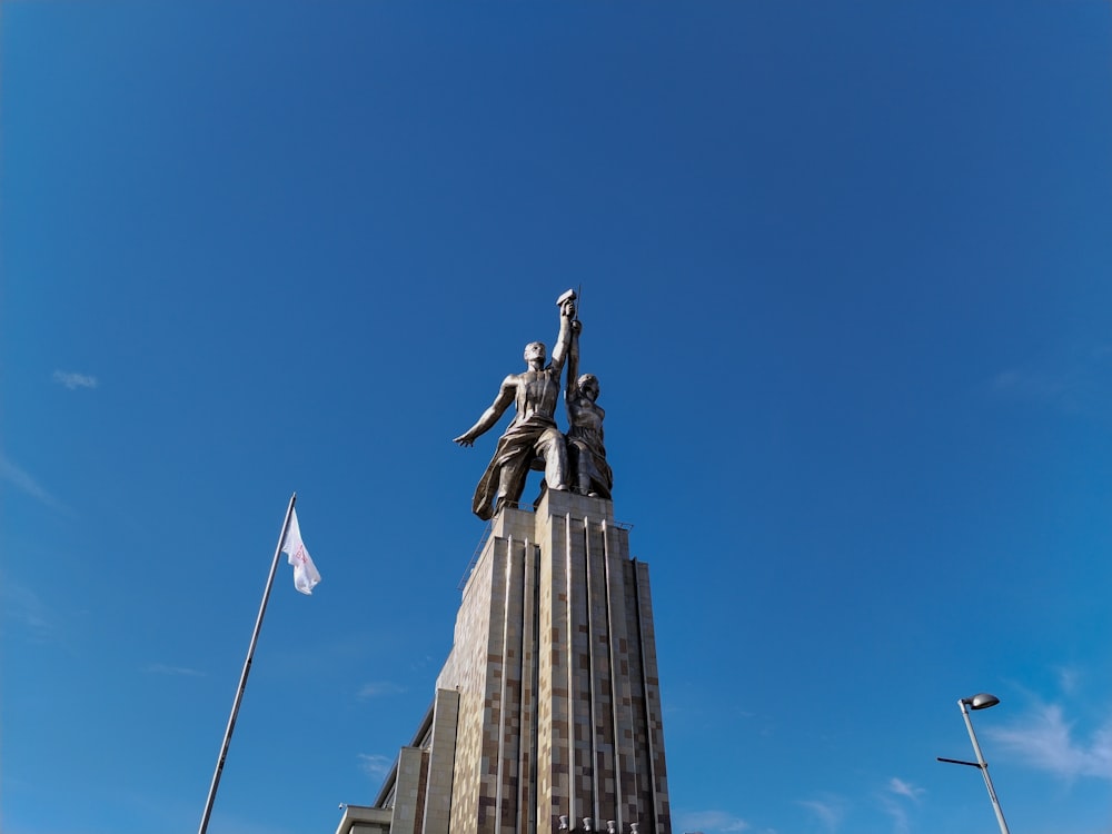 a tall building with a statue on top of it