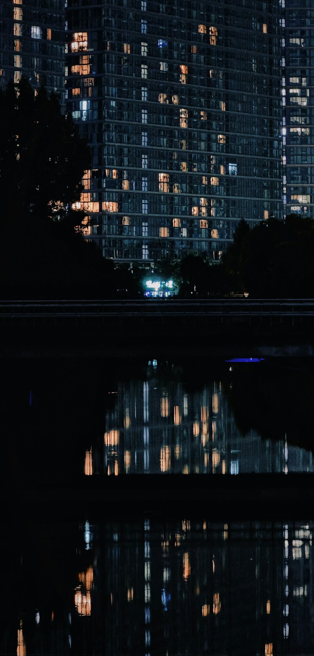 a city skyline at night reflected in a body of water