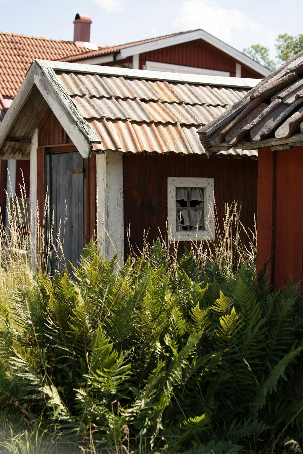 a small red house with a metal roof