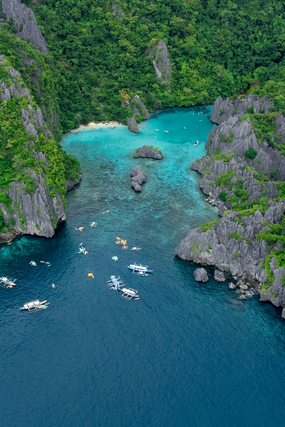 a group of boats floating on top of a blue river