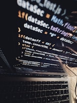 Close-up of a student writing Python code on a laptop with a focused expression.