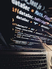 A sleek laptop screen displaying tenantjs’s framework with futuristic UI elements glowing softly.