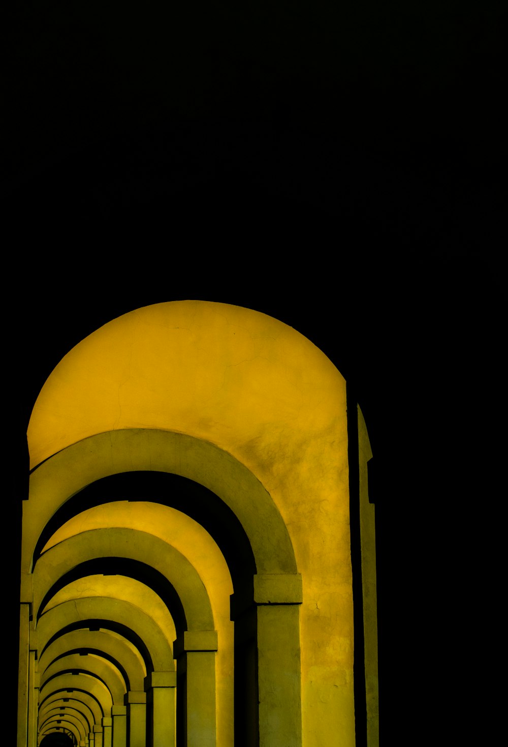 a row of arches lit up at night