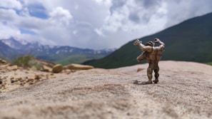 Adventure-themed collectible figurine posed dynamically on a rocky base