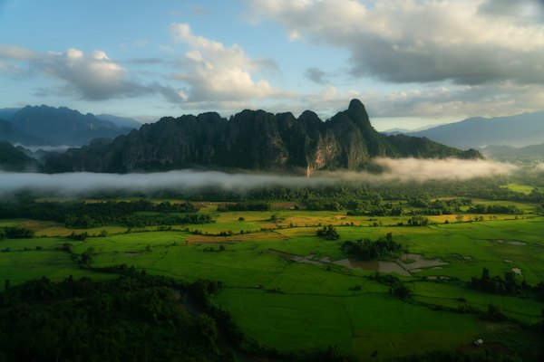 An aerial view of a mountain range in the clouds — Vang Vieng, Laos