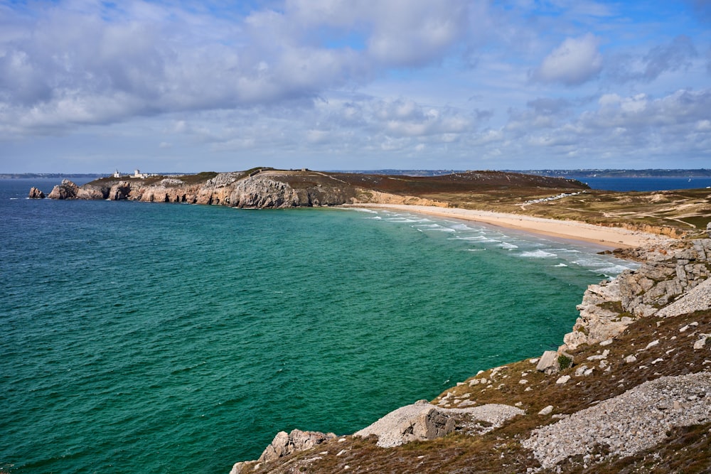 a view of a beach from the top of a hill