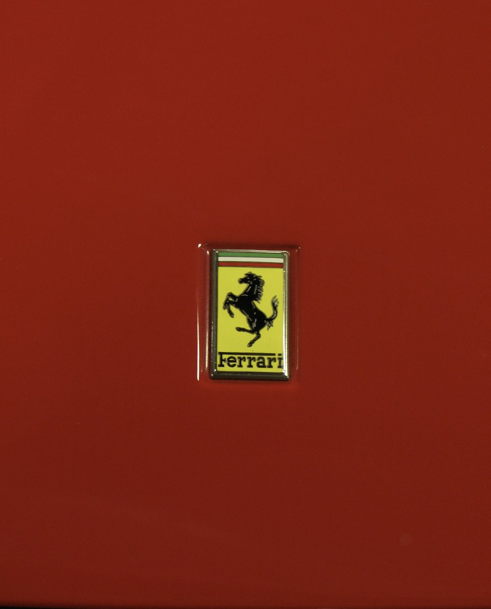 a ferrari emblem is shown on a red car