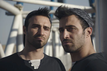 a couple of men standing next to each other