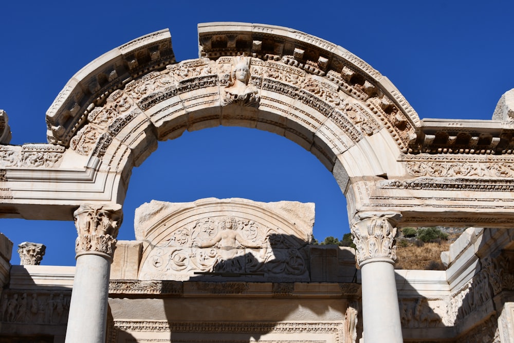 a stone arch with a blue sky in the background