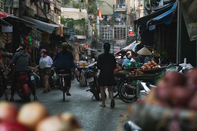 A bustling Vietnamese street market vibrant with fresh produce and local shoppers