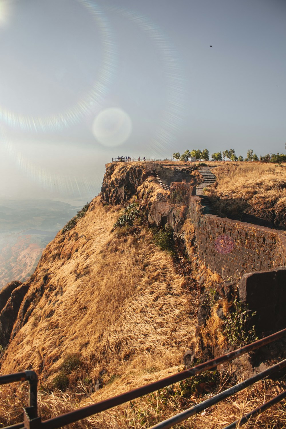 a view of a hill with a fence on top of it