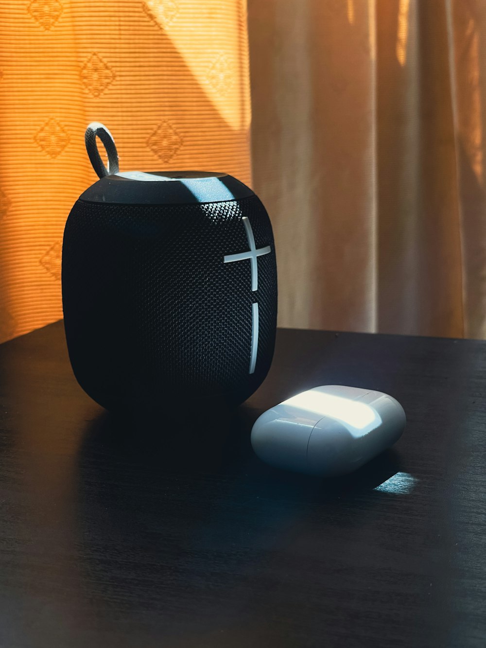 a black speaker and a white mouse on a table