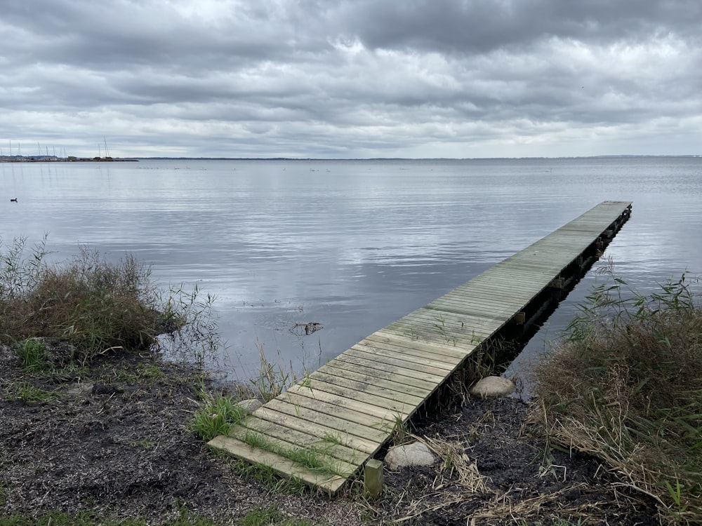 a wooden dock sitting in the middle of a body of water