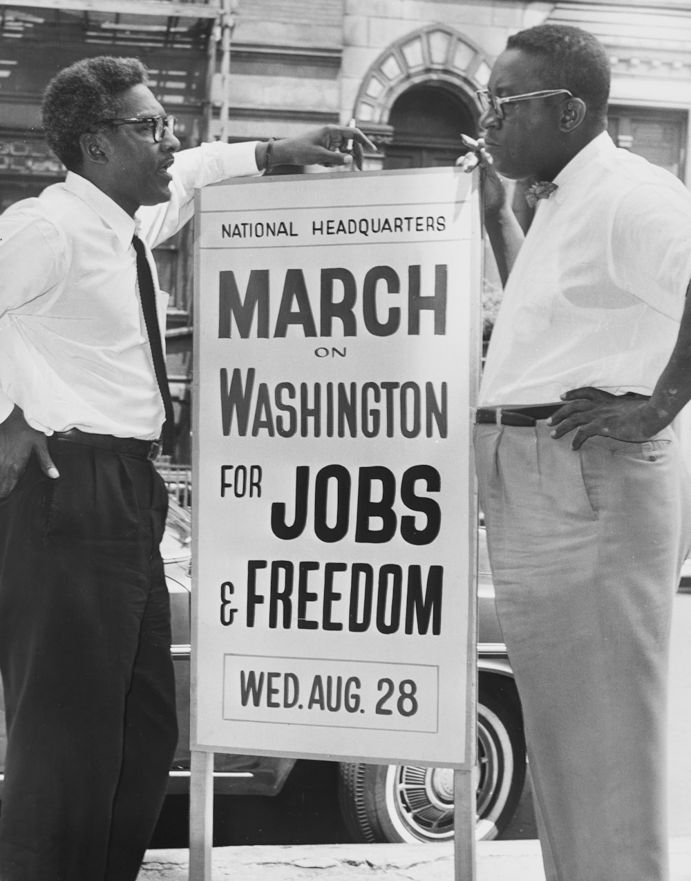 In front of 170 W 130 St., March on Washington, l t[o] r Bayard Rustin, Deputy Director, Cleveland Robinson, Chairman of Administrative Committee.