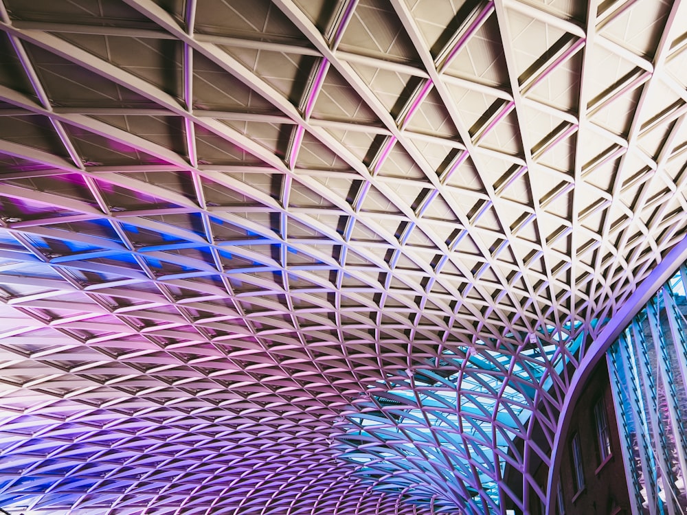 the ceiling of a train station with multiple colored lines