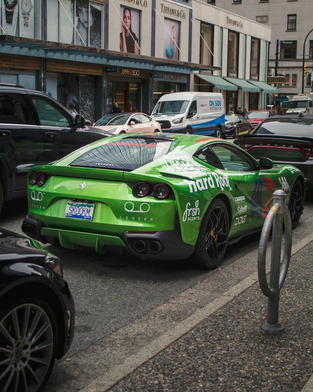 a green sports car parked on the side of the road