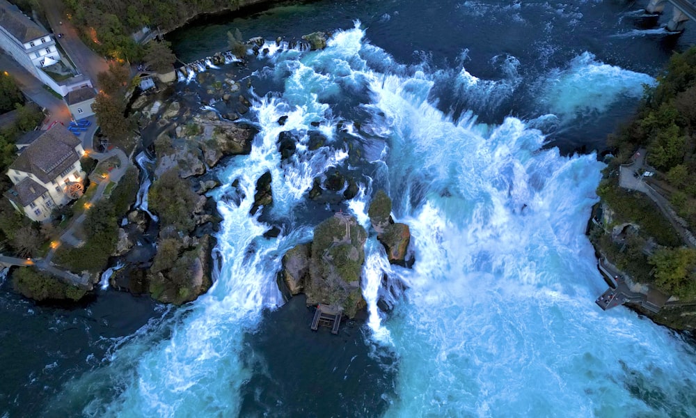 an aerial view of a waterfall in the middle of a river