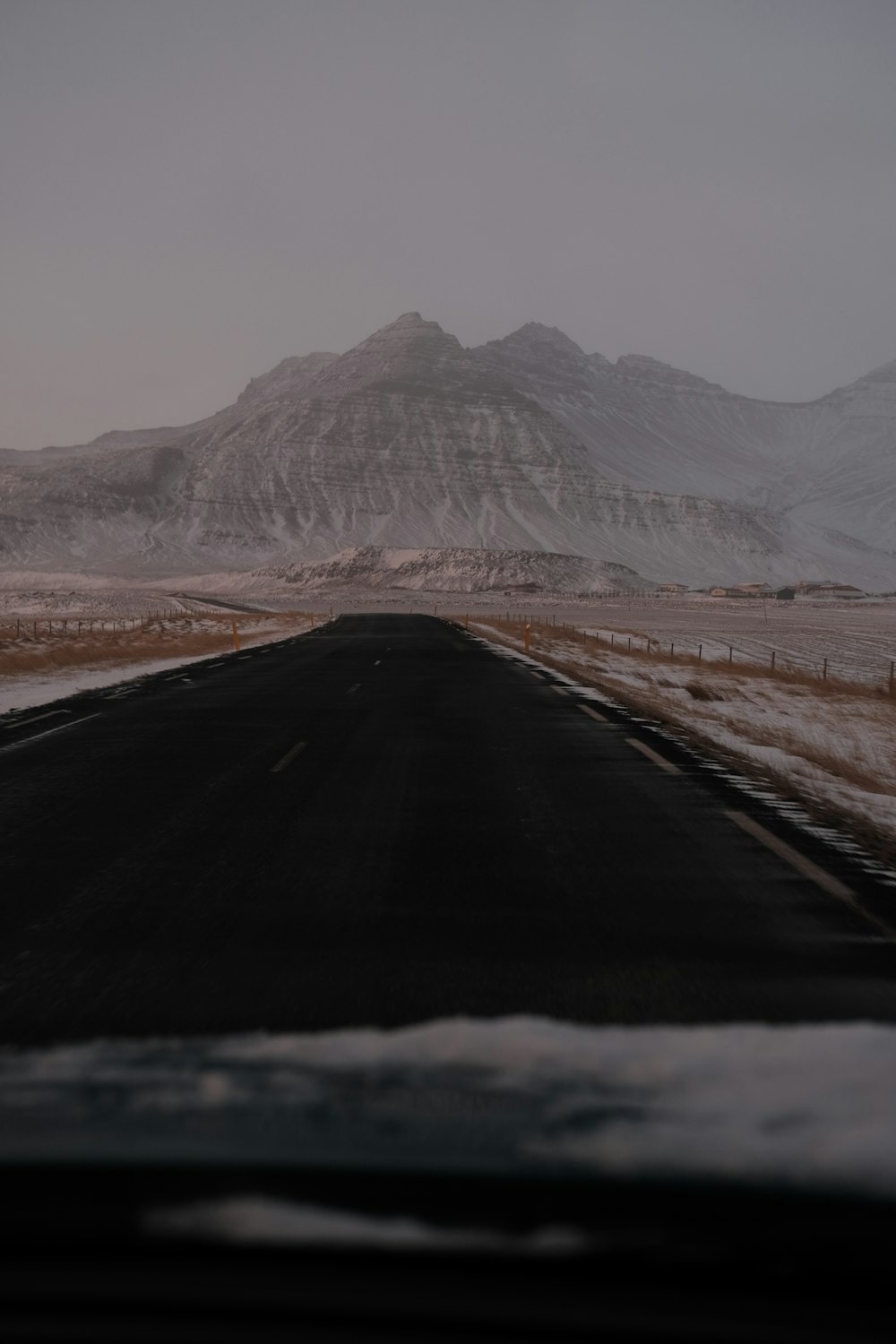 a car driving down a snow covered road