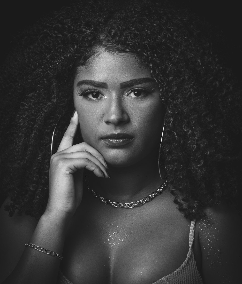 a black and white photo of a woman with curly hair