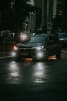 A sleek vehicle parked on a city street at dusk.