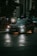 A sleek luxury car parked on a city street at dusk with soft ambient lighting.