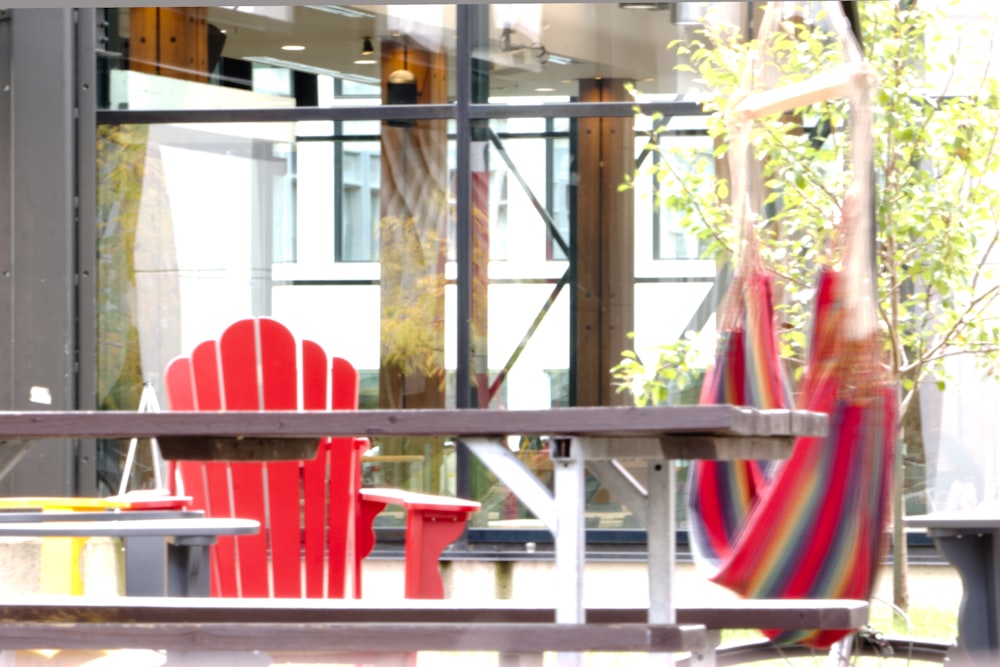 a red chair sitting in front of a window