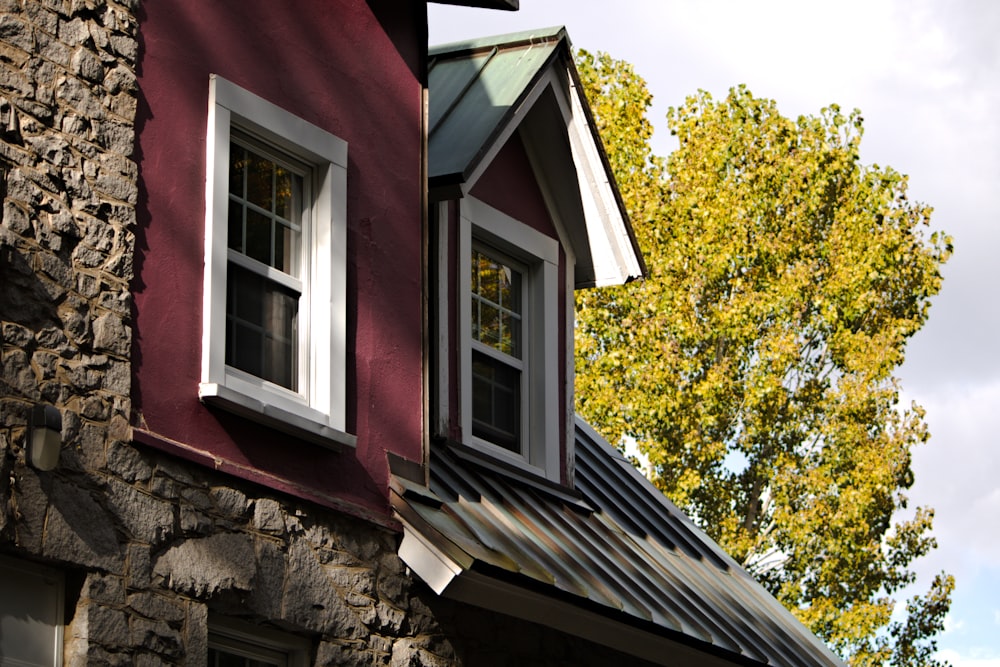 a house with a red roof and two windows