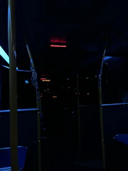 Close-up of a vibrant LED advertising screen inside a city bus showing dynamic content.