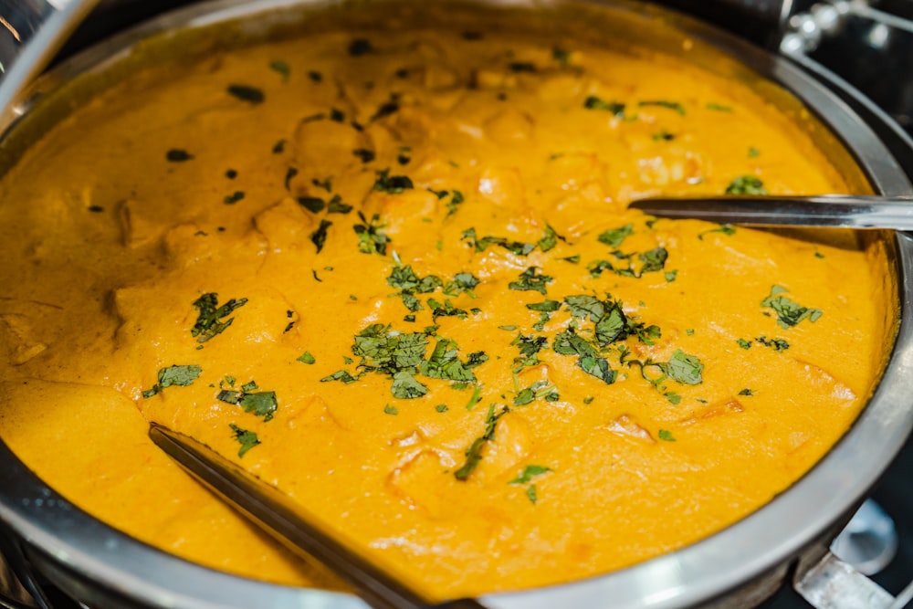 a bowl of soup with two spoons in it