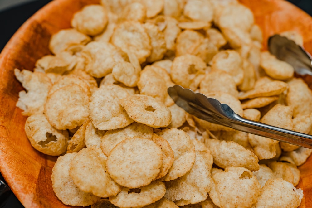 a bowl of crackers with a fork in it