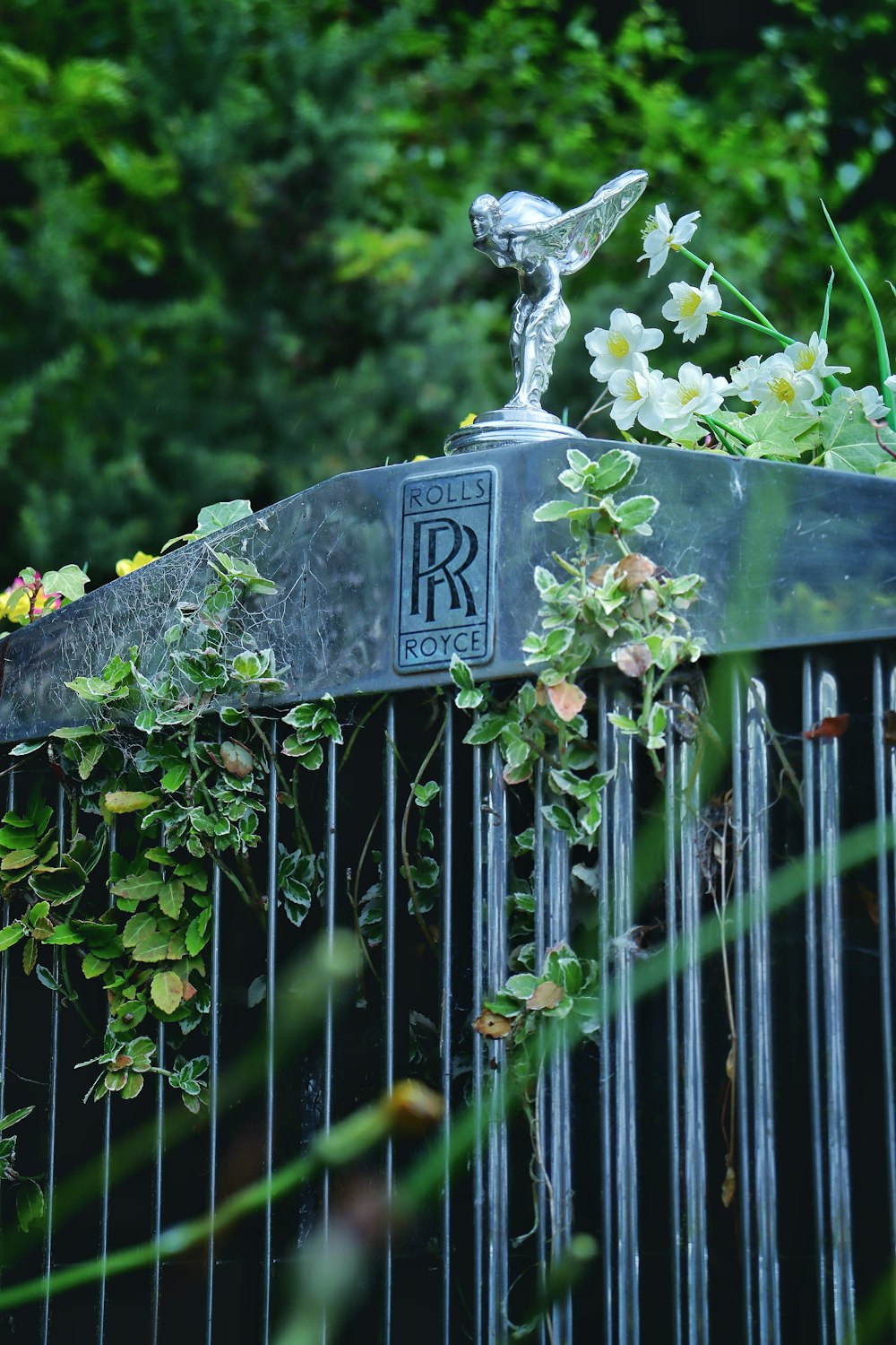 a statue of a bird on top of a fence