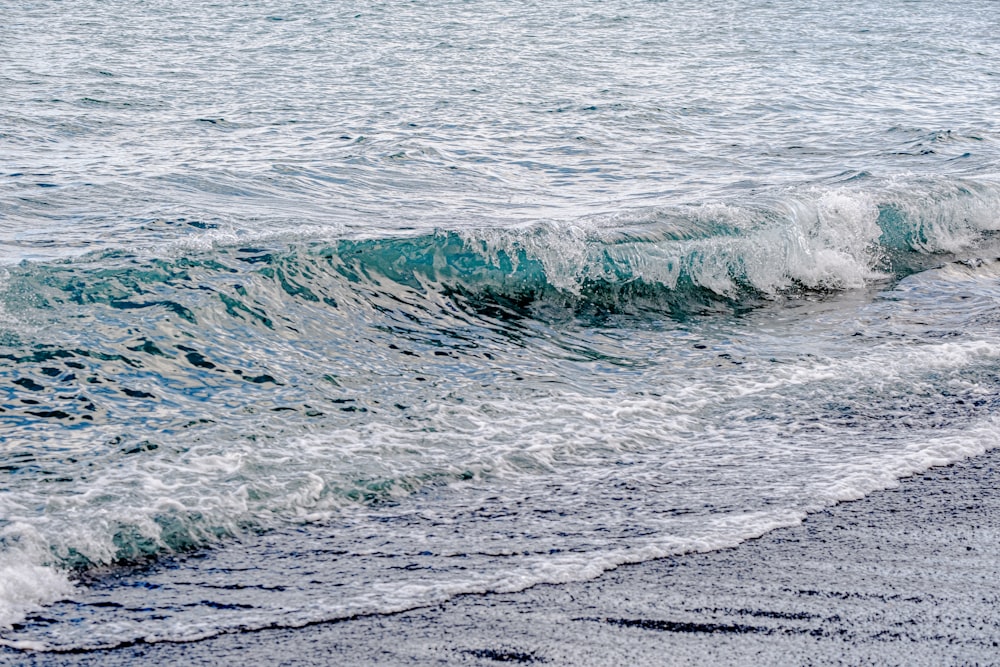 a person riding a surfboard on top of a wave