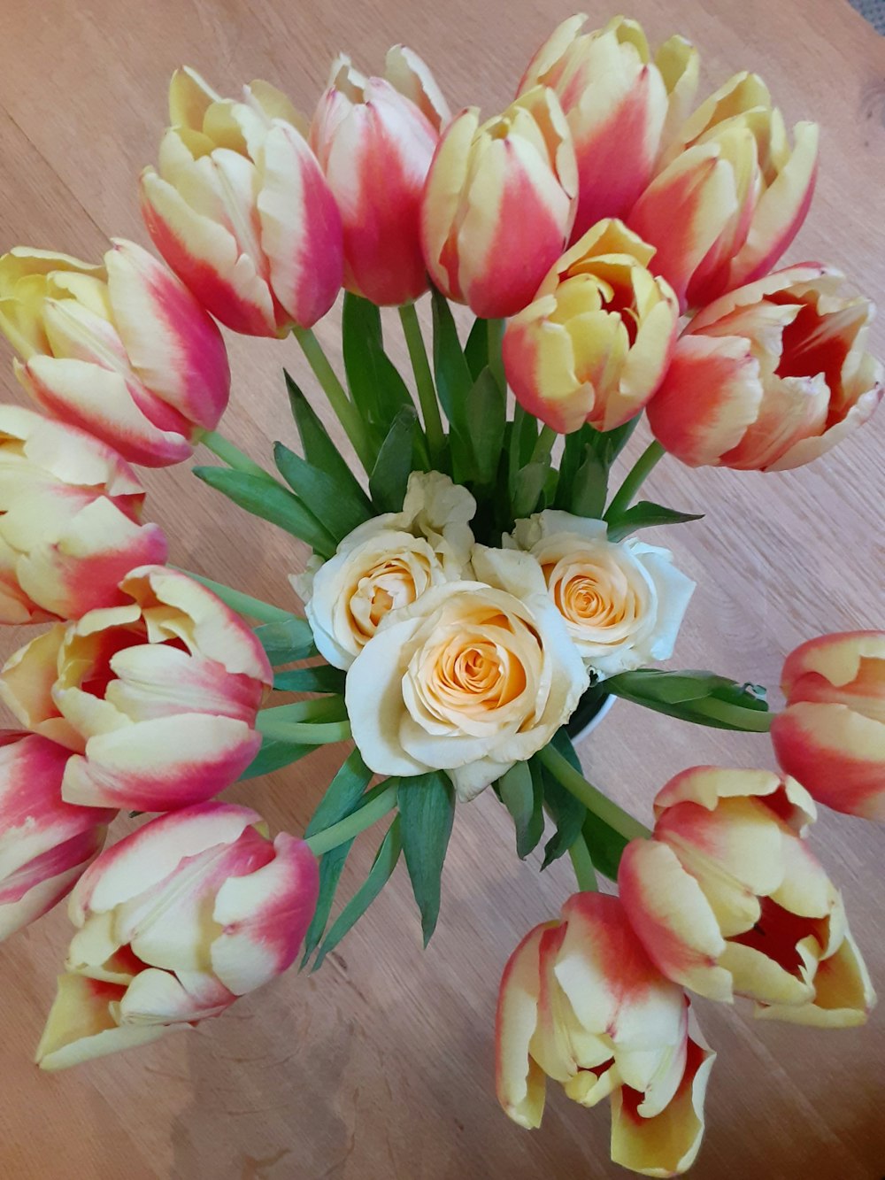 a bouquet of flowers sitting on top of a wooden table