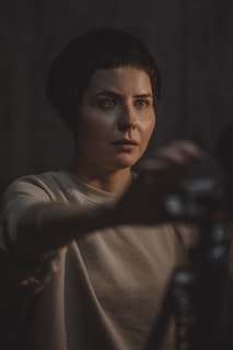 Author 5 in a minimalist studio setting, soft lighting highlighting their contemplative gaze.