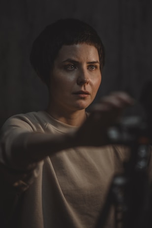 Author 5 in a minimalist studio setting, soft lighting highlighting their contemplative gaze.