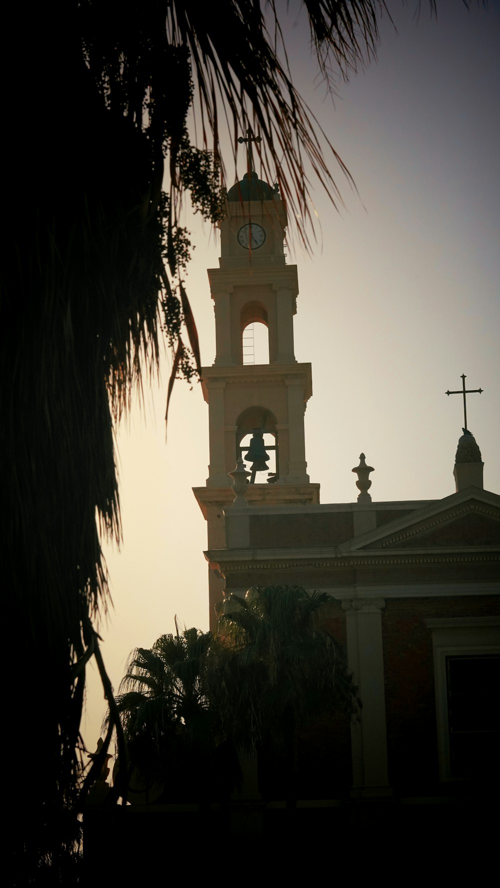 a church with a bell tower and a cross on top