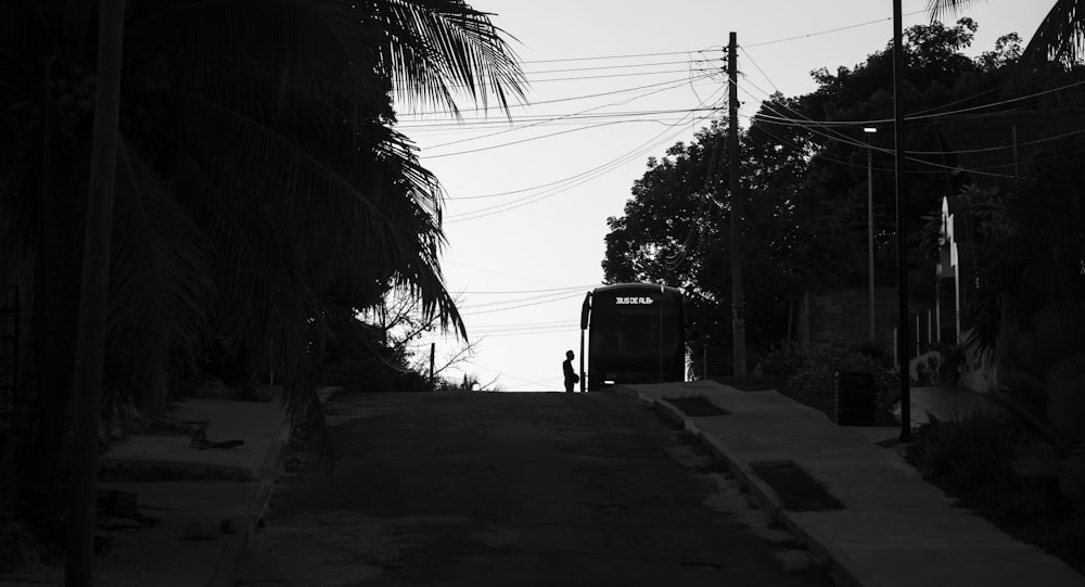 a black and white photo of a bus on a street