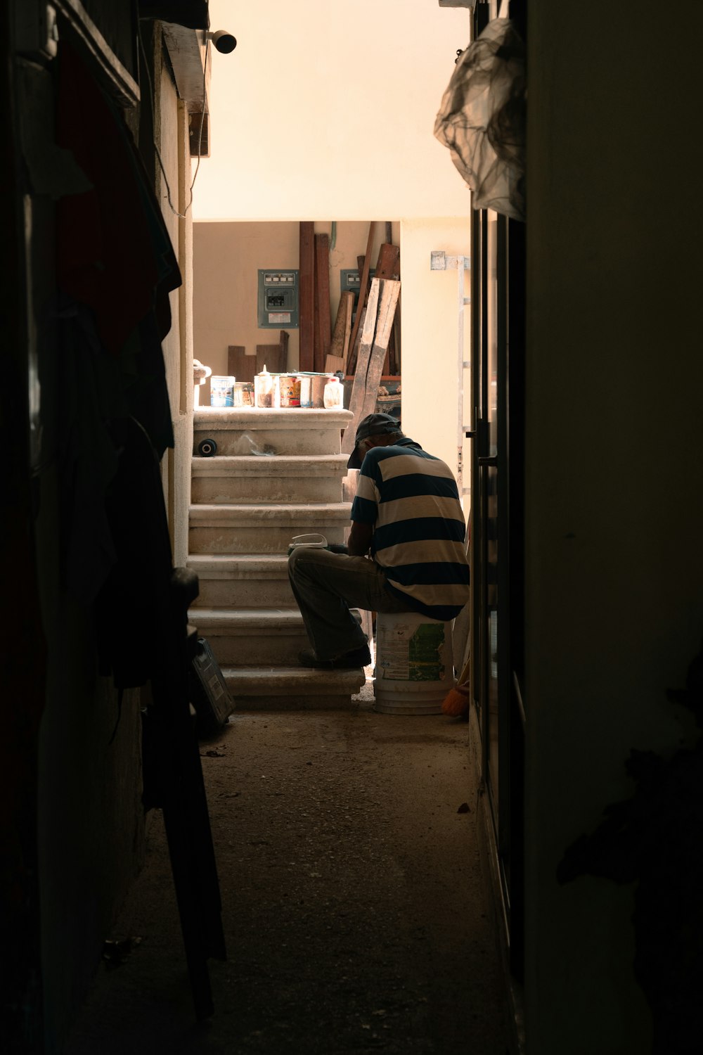 a man sitting on the steps of a house