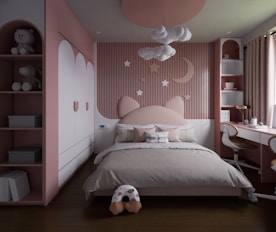 a child's bedroom with pink walls and white furniture