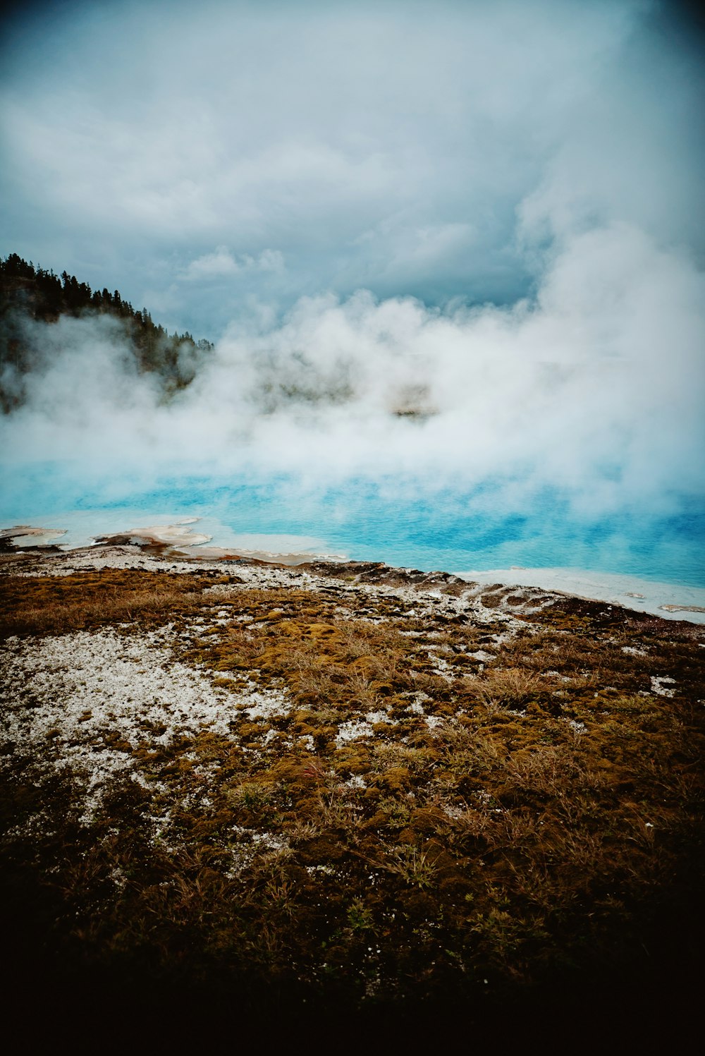 a large body of water with steam coming out of it